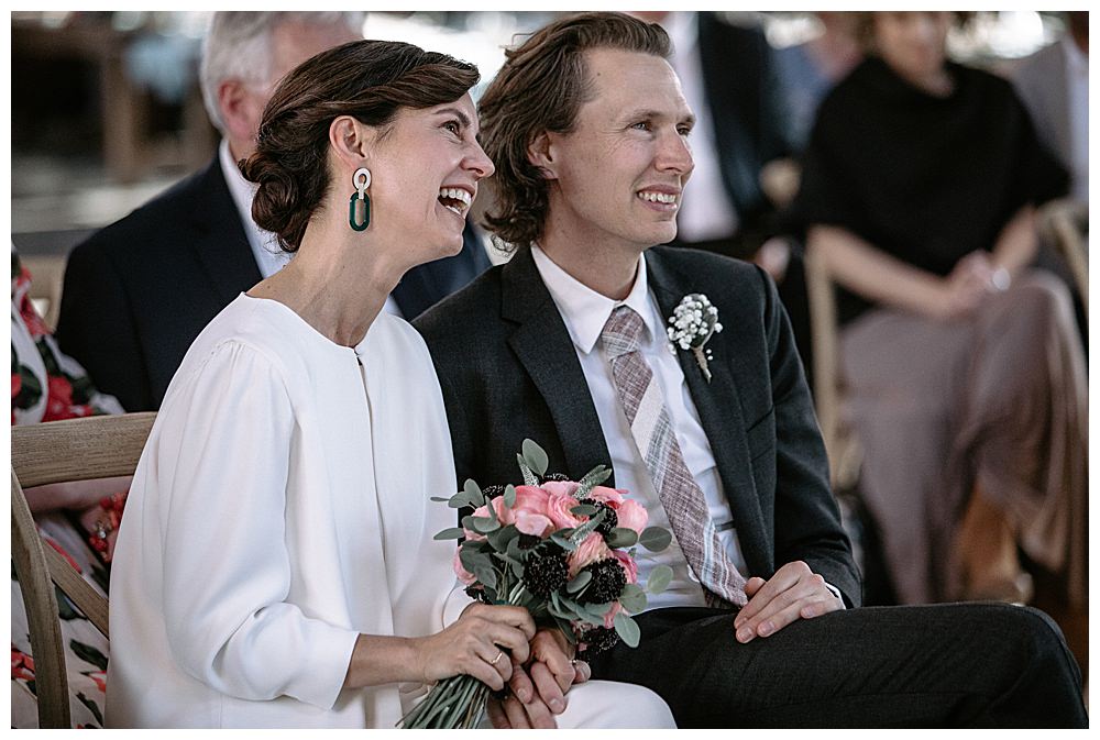 wedding-couple-sitting-with-guests