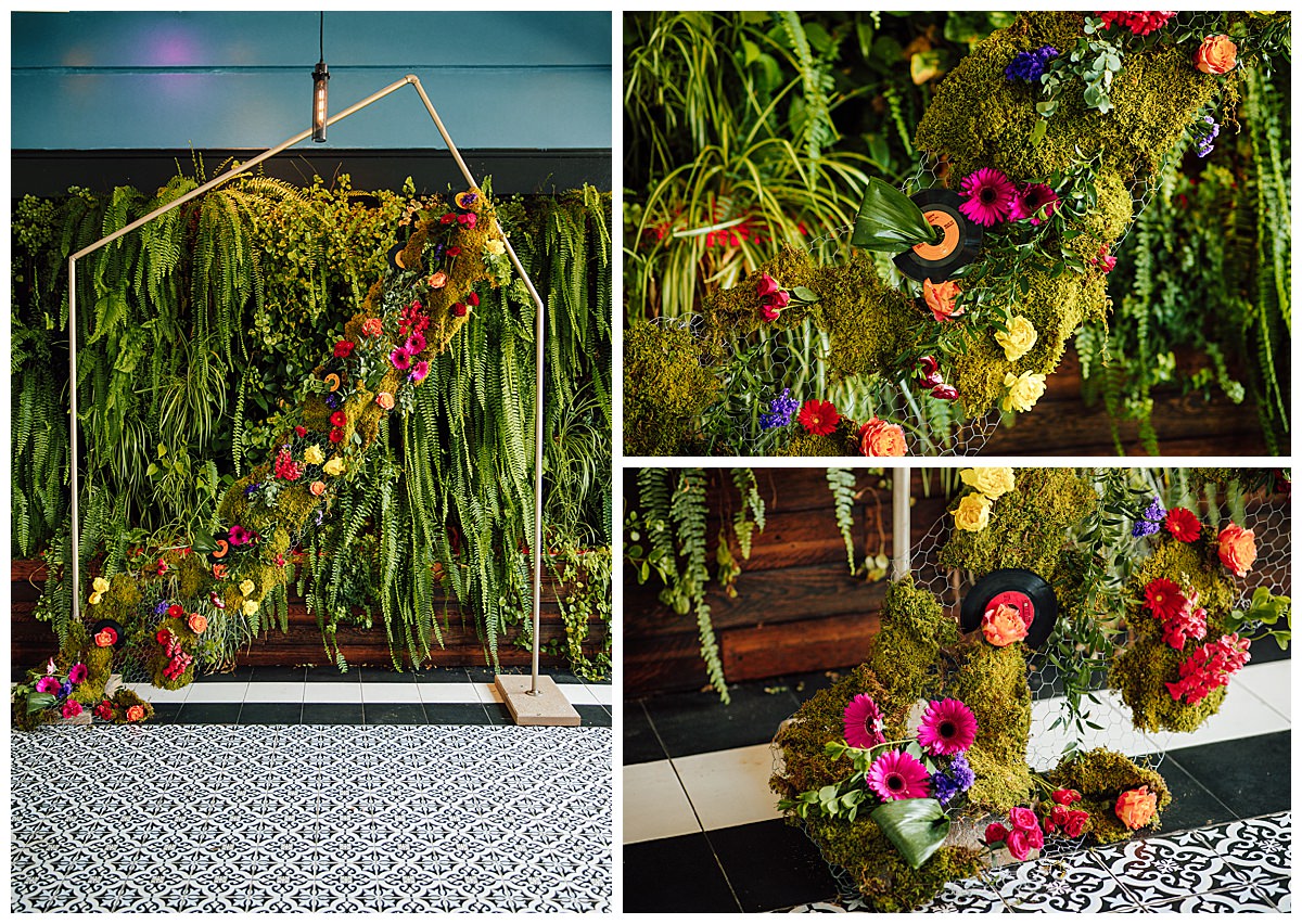 wedding-ceremony-backdrop-with-florals-and-records