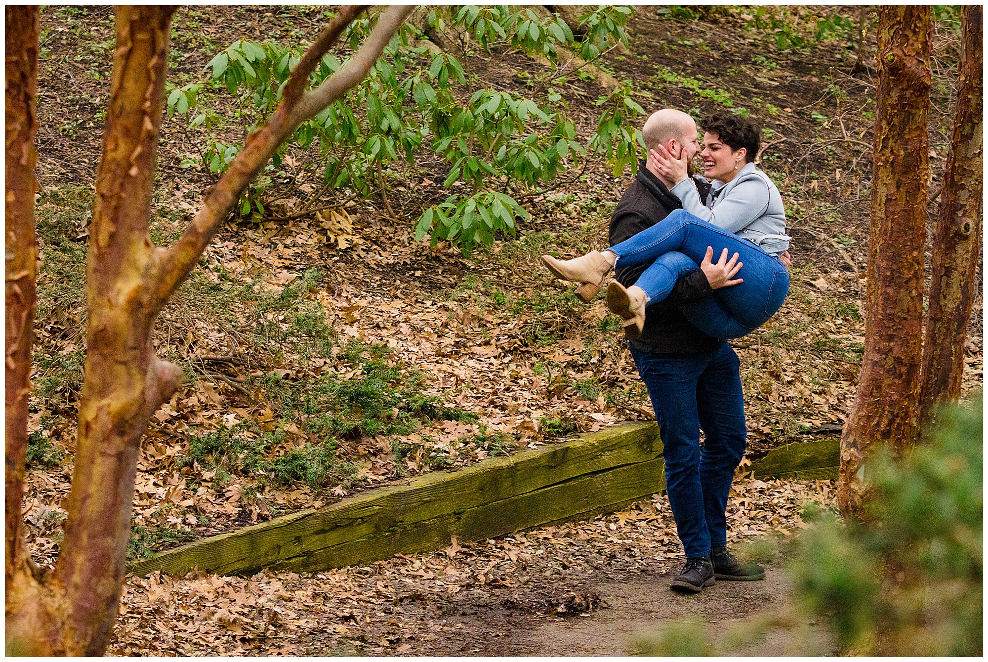 A man carries his fiance in highland park after he just proposed