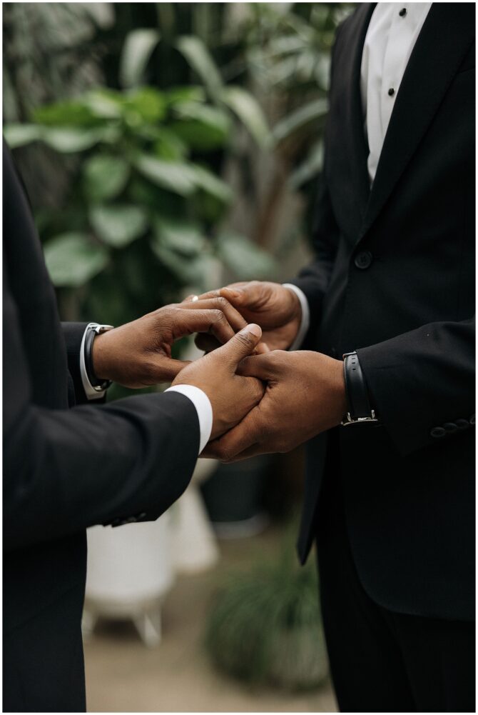 Couple holding hands during wedding ceremony.