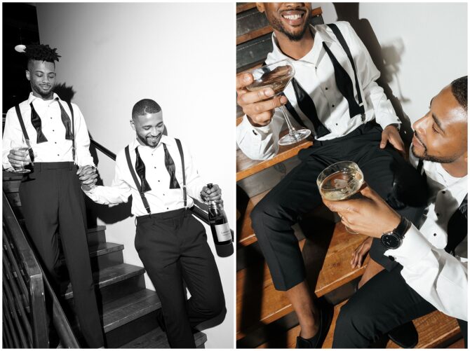 Two men celebrating with champagne on stairs.