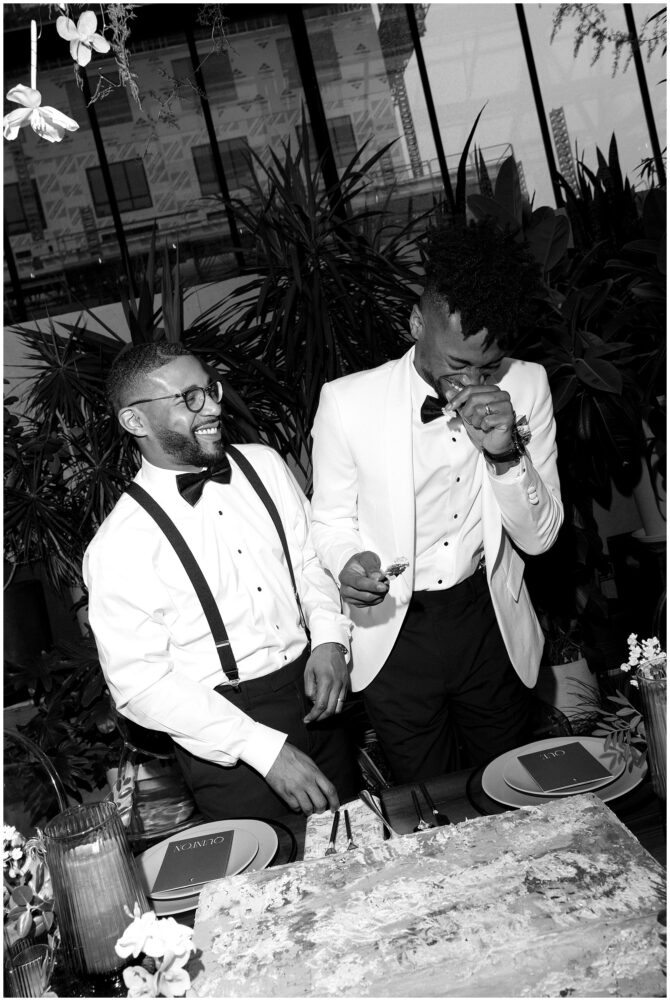 Two men in formal attire laughing together.