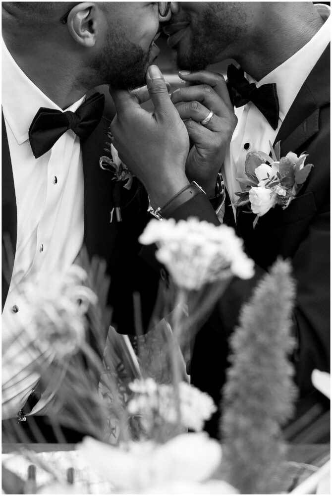 Two grooms embrace on their wedding day.