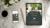 Wedding invitation on tablet and phone with coffee.