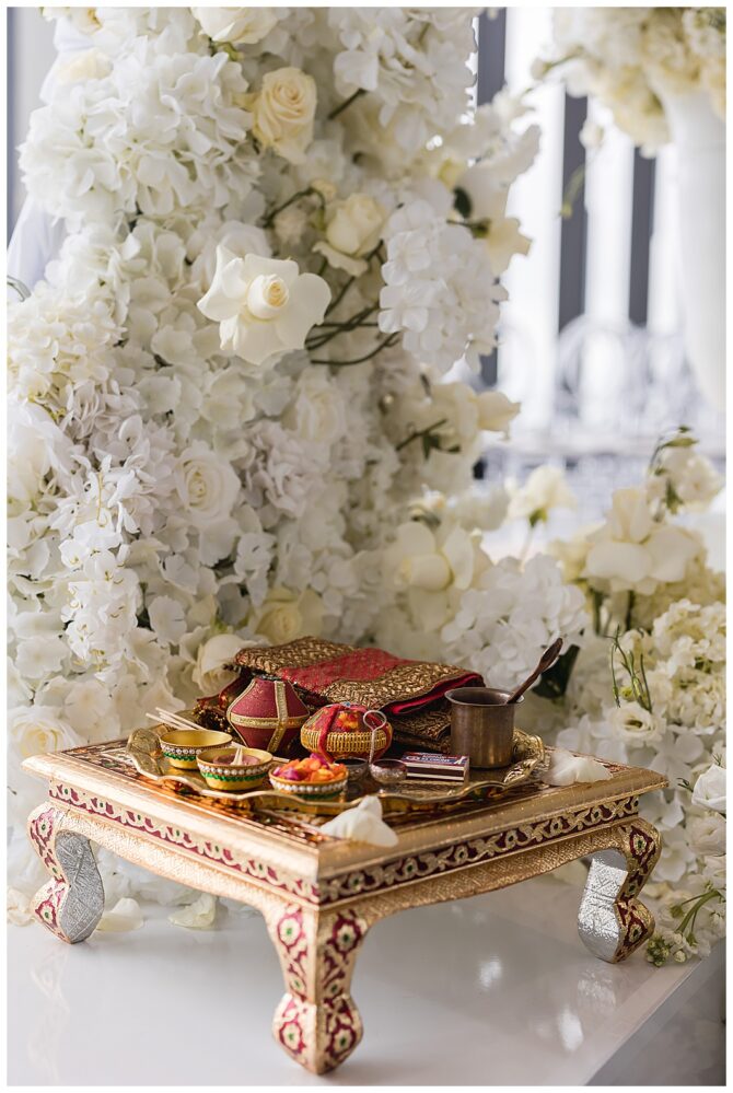 Traditional offering table with flowers and items.
