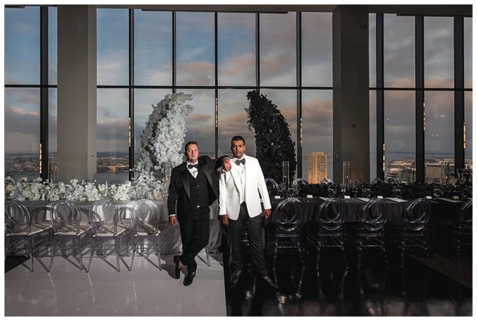 Two men in tuxedos at a decorated event.