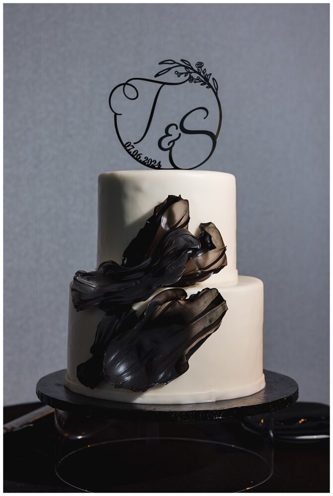 Elegant wedding cake with black chocolate decoration.