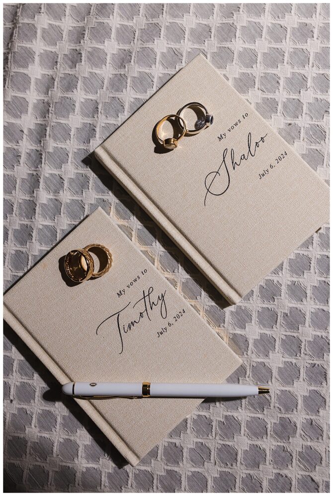 Wedding vow books with rings and pen.