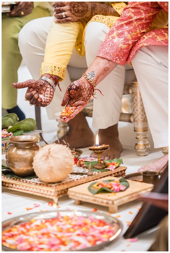 Traditional Indian ceremony with decorative items and flowers.