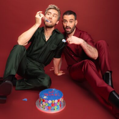 Two men eating cake celebrating 10 years anniversary.