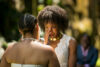 Emotional wedding ceremony with two women exchanging vows.