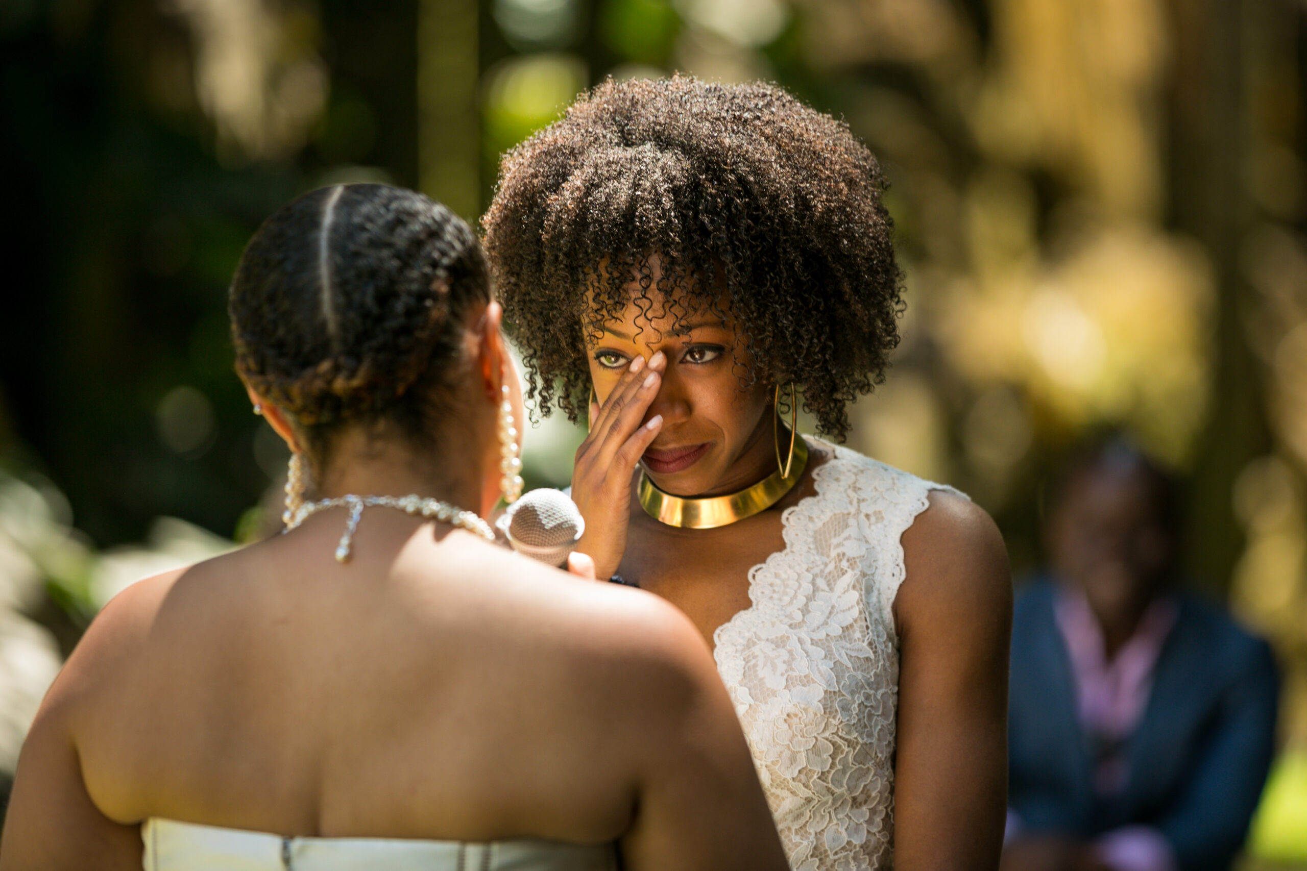 Emotional wedding ceremony with two women exchanging vows.