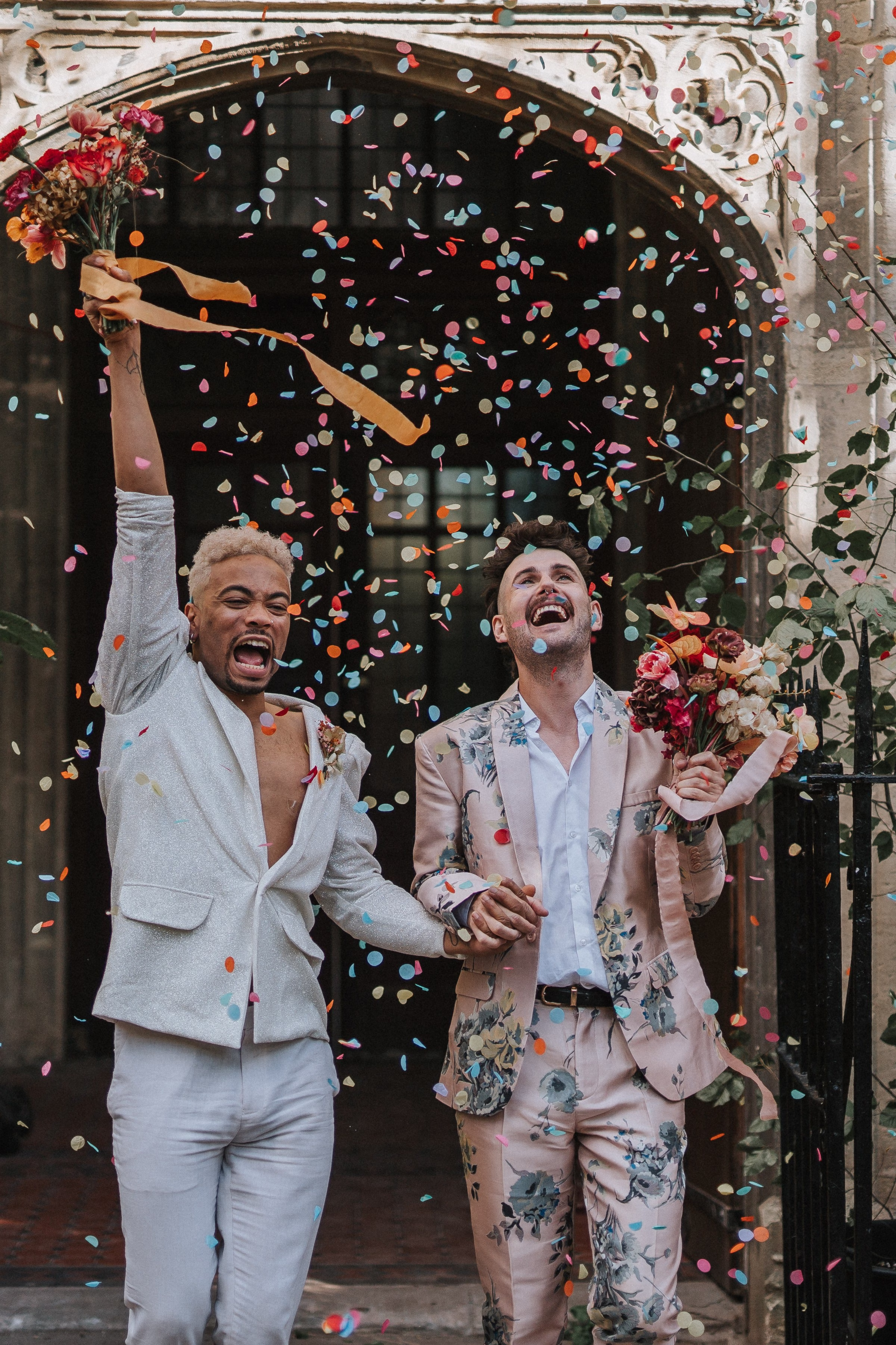 two grooms colorful confetti celebration joyful wedding